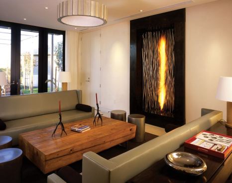 The wine-tasting room has a large vertical fire feature along one of its walls.