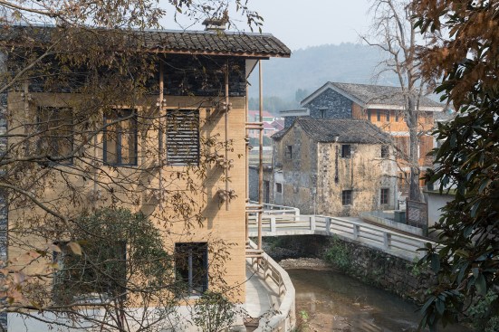 View of old and new residences as seen from the border of the new village neighborhood, which extends  to the left