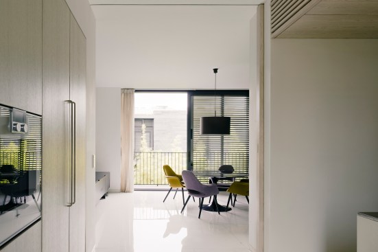 Windows bring natural light into the minimal interiors, and are aligned both north to south and east to west to maximize views through the buildings.