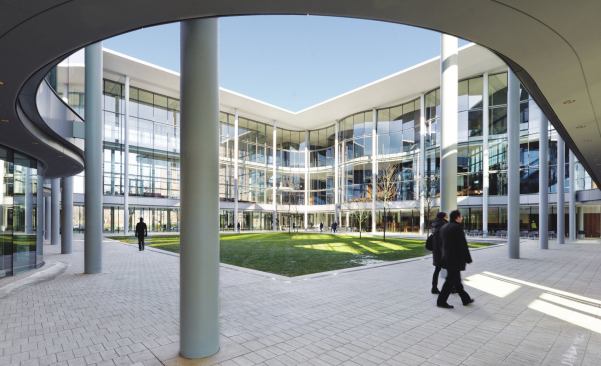 The north and south walls of the central courtyard feature undulating curves that reflect the elliptical classroom spaces within.
