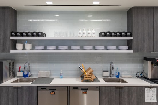 The pantry at Dattner Architects with reusables dishware and zero-waste guidelines posted.